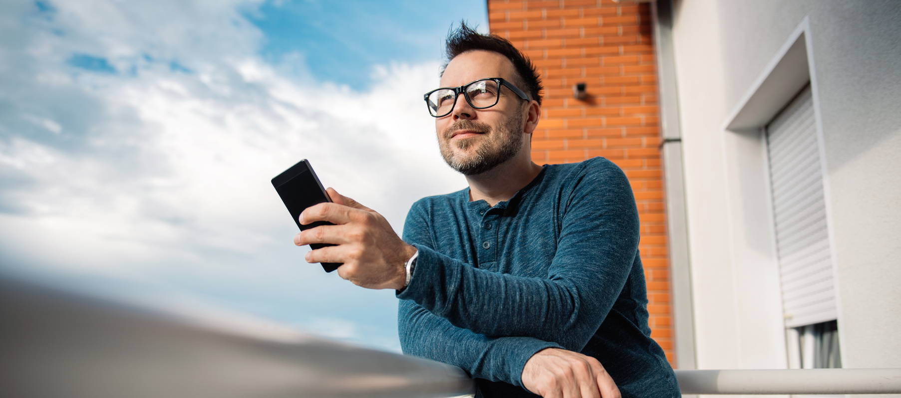Smiling men typing text message
